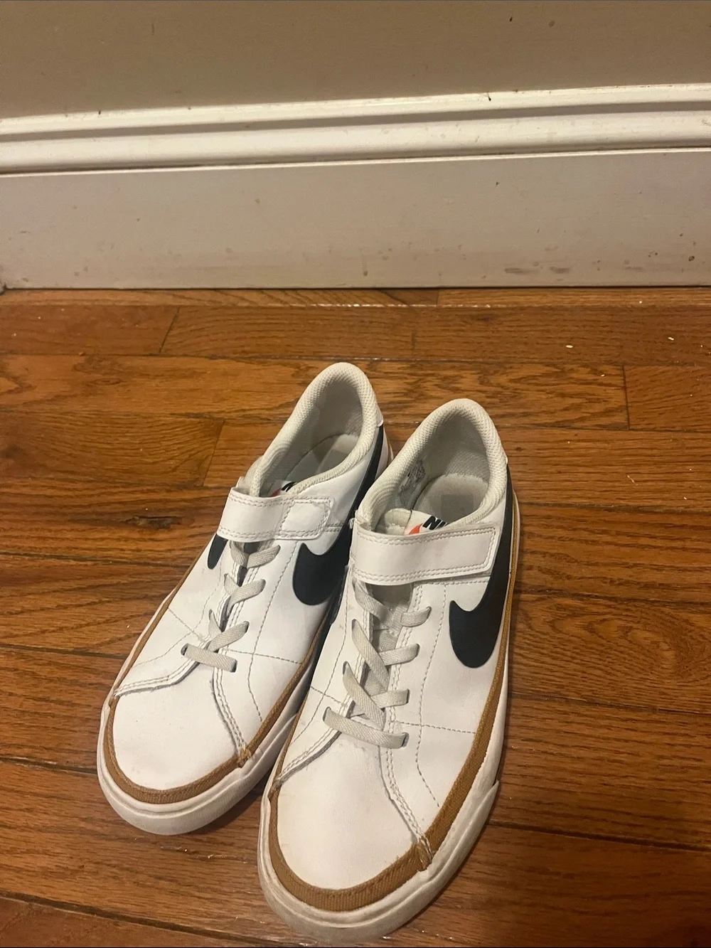 Nike White Kids Sneakers with Black Swoosh and Tan Accent